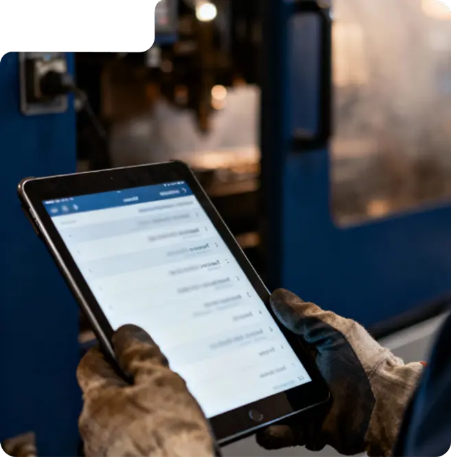 A maintenance operator holding a tablet
